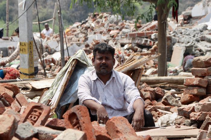 Residents pick through the rubble of a demolished jhuggi cluster in Delhi. At Bela Estate, those who stayed on after demolitions found 728 of 729 voters at their booth deleted from the draft roll
